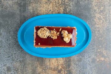 Slice of caramel cake on blue plate