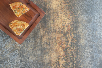 A wooden board with slices of delicious pastry