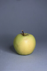 green apple isolated on gray background. Image contains copy space