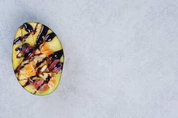 Obraz na płótnie Canvas Fresh avocado with chocolate and fruits up view