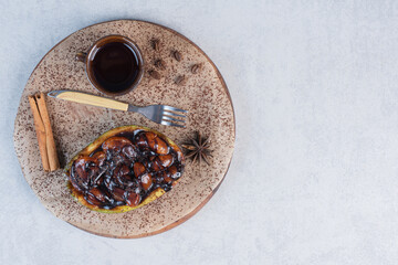 Sweet chocolate dessert with cup of coffee on wooden board