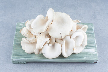 Close up photo of oyster mushroom on wooden board