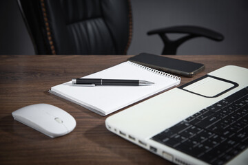 Office workplace. Notepad, smartphone, laptop computer, mouse.