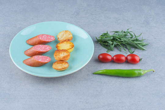 Snack concept. Salami and fried potato.