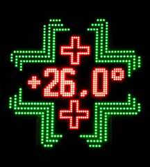 Pharmacy LED panel shows a temperature of 26 degrees celsius at night , black background
