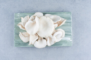 Fresh organic oyster mushrooms on wooden board