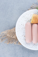 Sausage and Boiled potato on white plate