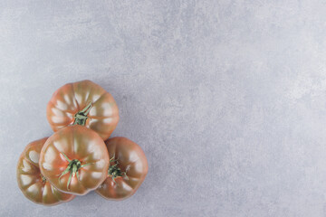 Fototapeta na wymiar A stack of tasty tomatoes on the marble background