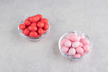 Two bowl of gums on the blue background