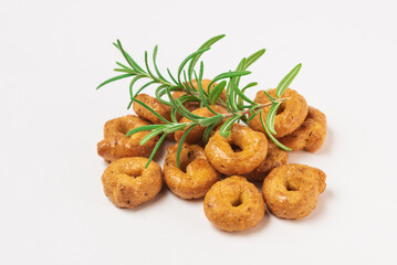 Traditional italian snacks taralli or tarallini with rosemary isolated on white background
