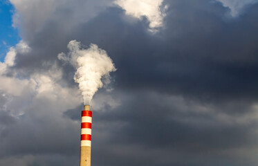 Factory chimney smoke with blue sky and clouds
