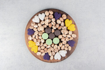 Different kinds of cookies on the tray, on the marble background