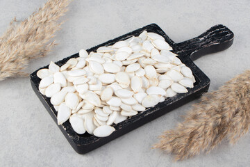 A tray of kernel and pampas grass, on the marble background