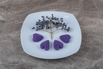 Cookies and grapes on the plate ,on the marble background