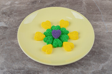 Green and yellow cookies ,on the plate, on the marble background
