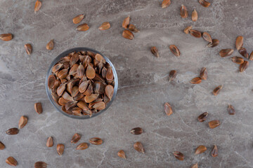 Toothsome seeds in a bowl ,on the marble background