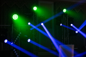 multiple spotlights on a theatre stage lighting rig