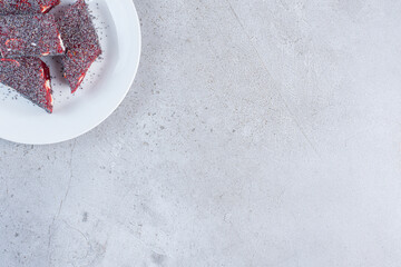 A serving of flavored and colored Turkish delights on a platter on marble background