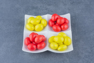 Lined gums on the plate, on the marble background