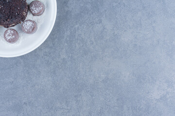 Chocolate cake and sweet cookie, on the marble background
