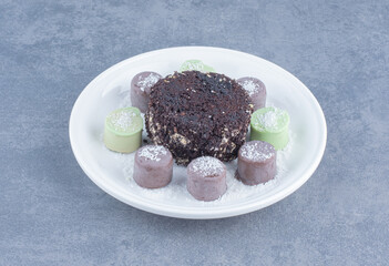Chocolate cake and sweet cookie, on the marble background