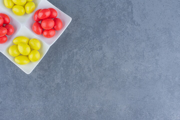 Lined gums on the plate, on the marble background