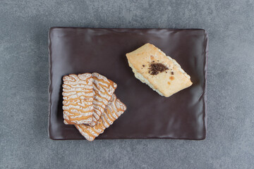 Delicious fresh pastries on a brown plate