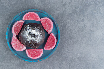 Chocolate muffin with fruit jelly candies