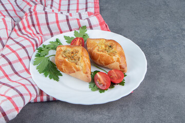 Delicious pastries with cherry tomatoes in a white plate