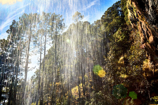 waterfall view from behind and cloud sky and pine trees in mexiquillo durango 