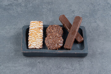 Cookies with chocolate round cookies on a dark board