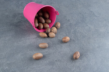 A pink bucket full of healthy almond