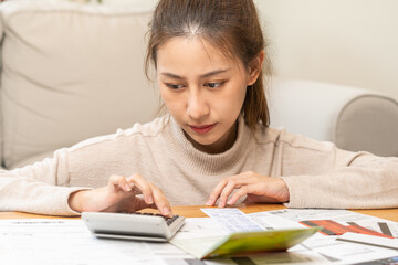 Financial owe asian young woman, girl sitting suffer, stressed and confused by calculate expense from invoice or bill, have no money to pay, mortgage or loan. Debt, bankruptcy or bankruptcy concept.