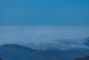Panoramic view form mountains peak on the fog and clouds. Sunrise landscape. 