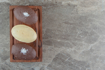 Three cupcake with frosting on marble background