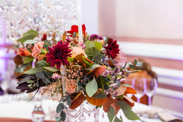 Rustic wedding decoration for festive table with beautiful flower composition. Autumn wedding.