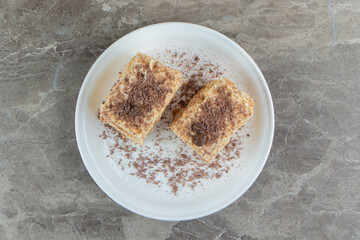 Slices of napoleon cake on white plate