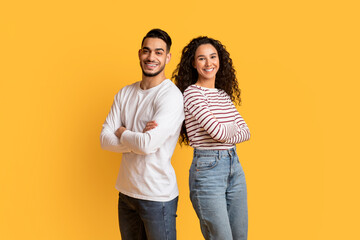Portrait Of Cheerful Middle Eastern Man And Woman Posing Over Yellow Background