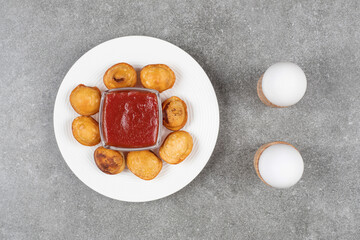 Delicious fried dumplings on white plate with ketchup