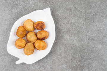 Delicious fried dumplings on white plate