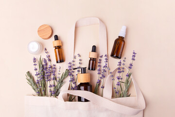 Open eco friendly cotton reusable bag with the different containers.Pastel colors.Natural lavender around.Concept of organic,zero waste cosmetics.Woman bag with accessories.
