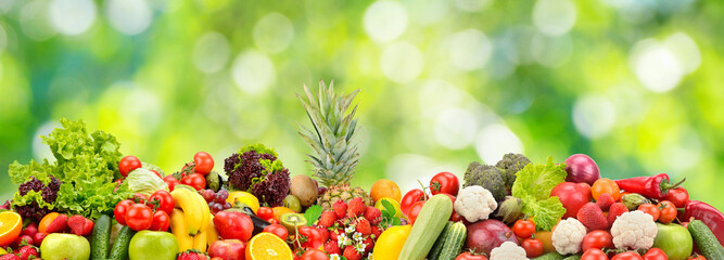 Collage fresh vegetables, fruits, berries on green background.