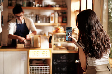 Woman Filming Coffeeshop Worker