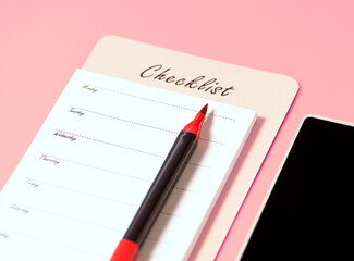Planning calendar notebook with red pen and phone