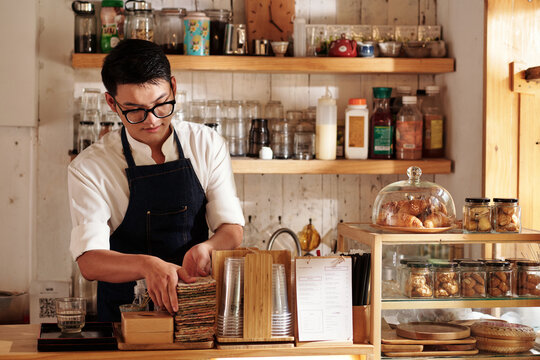 Barista Cleaning up Counter - Powered by Adobe