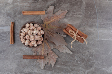 Leaves, confectionery and cinnamons, on the marble background