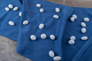 Delectable gumballs on the towel ,on the marble background