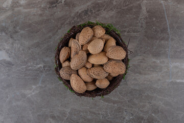 flavorful almonds in a bowl, on the marble background