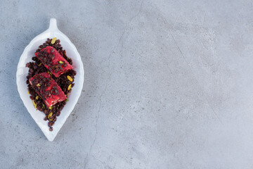 A small platter with flavored and colored Turkish delights on marble background