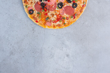 Delicious pizza displayed on marble background